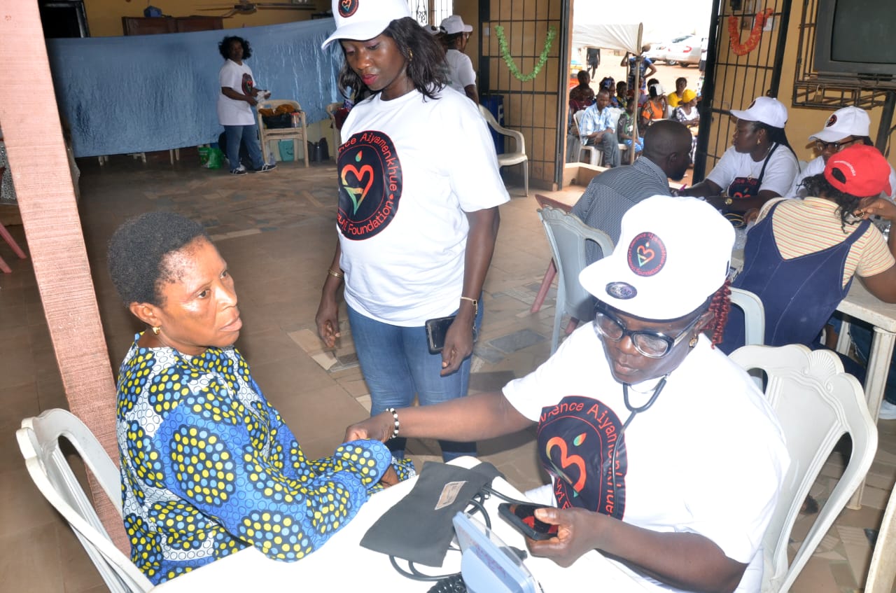 A LAOF volunteer assisting a seated outreach participant