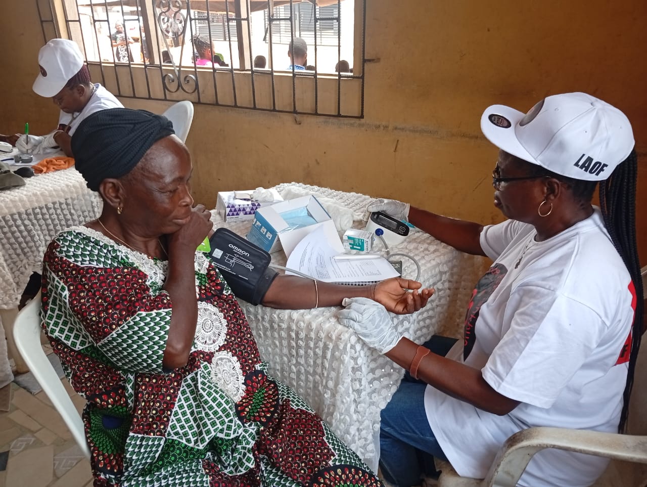 A LAOF volunteer talking with a participant at an outreach table