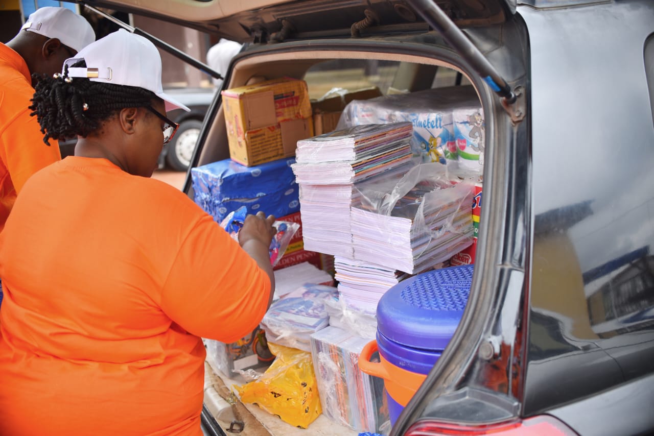 A volunteer arranging donated boxes in the back of a vehicle