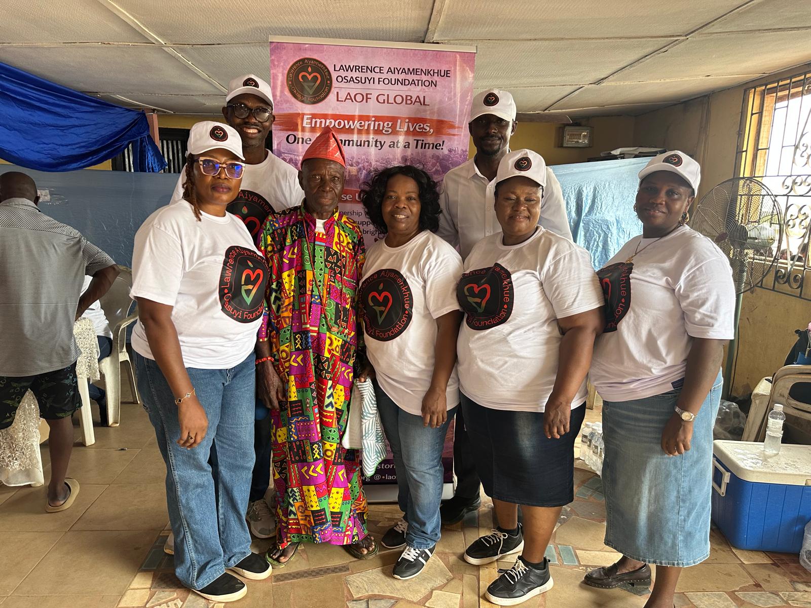 LAOF volunteers and community representatives gathered by an outreach banner