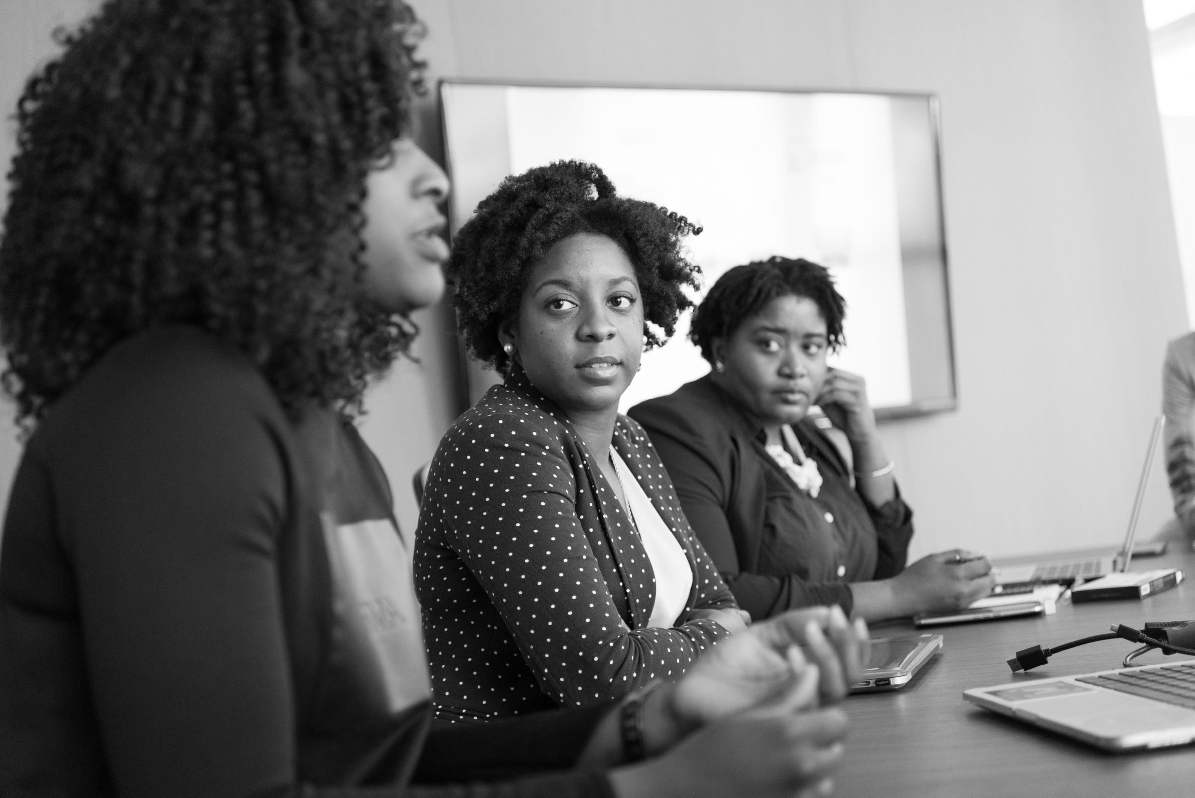 Illustrative photo: Women discussing ideas around an office table