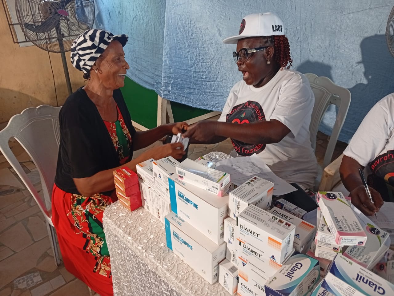 A LAOF volunteer discussing medical supplies with an outreach participant