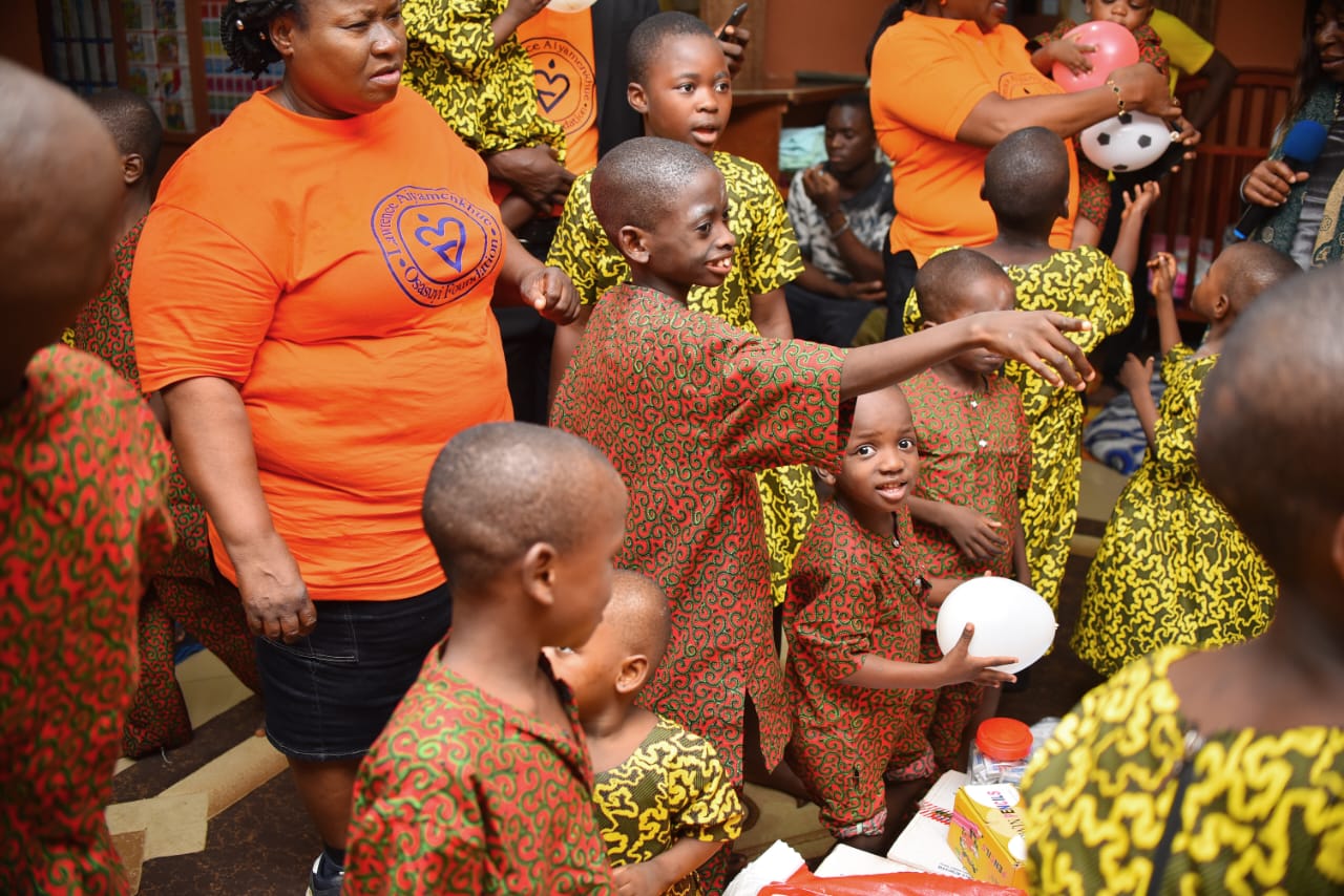 A volunteer engaging with children during an outreach visit