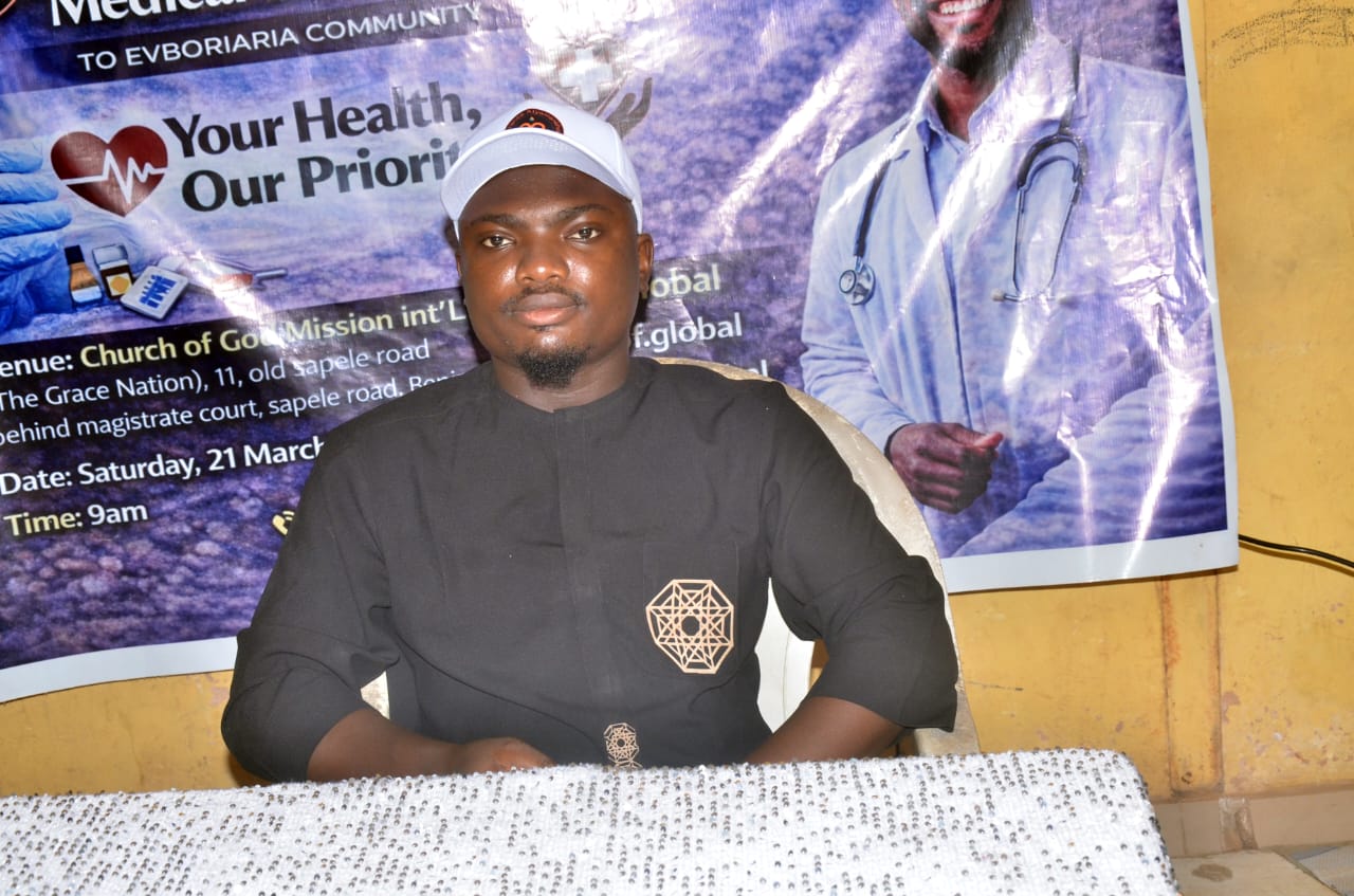 A LAOF representative seated in front of a health outreach banner