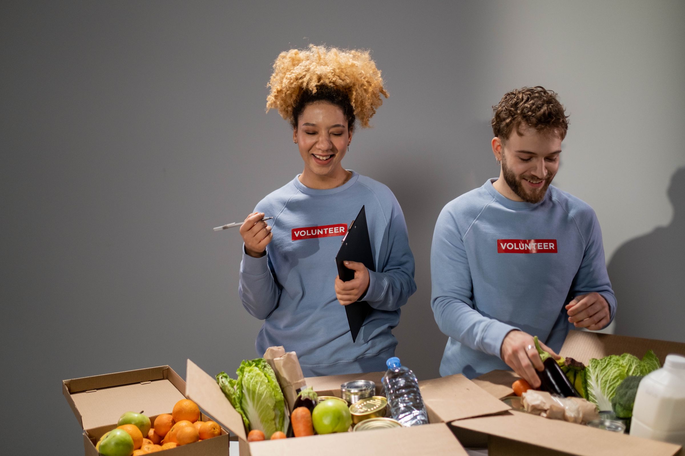 Illustrative photo: Two volunteers checking and packing donated produce