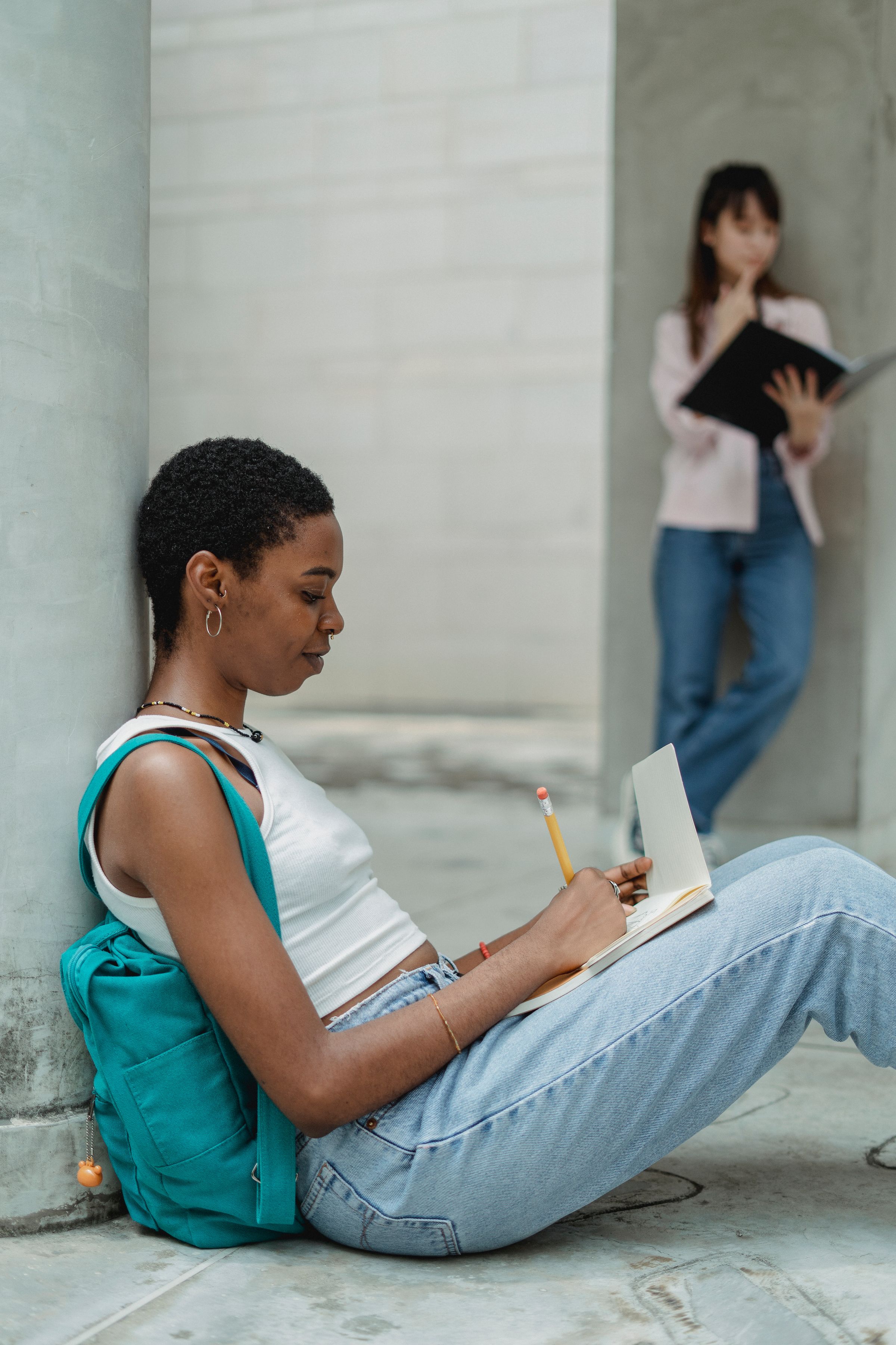 Illustrative photo: A student taking notes while studying outdoors