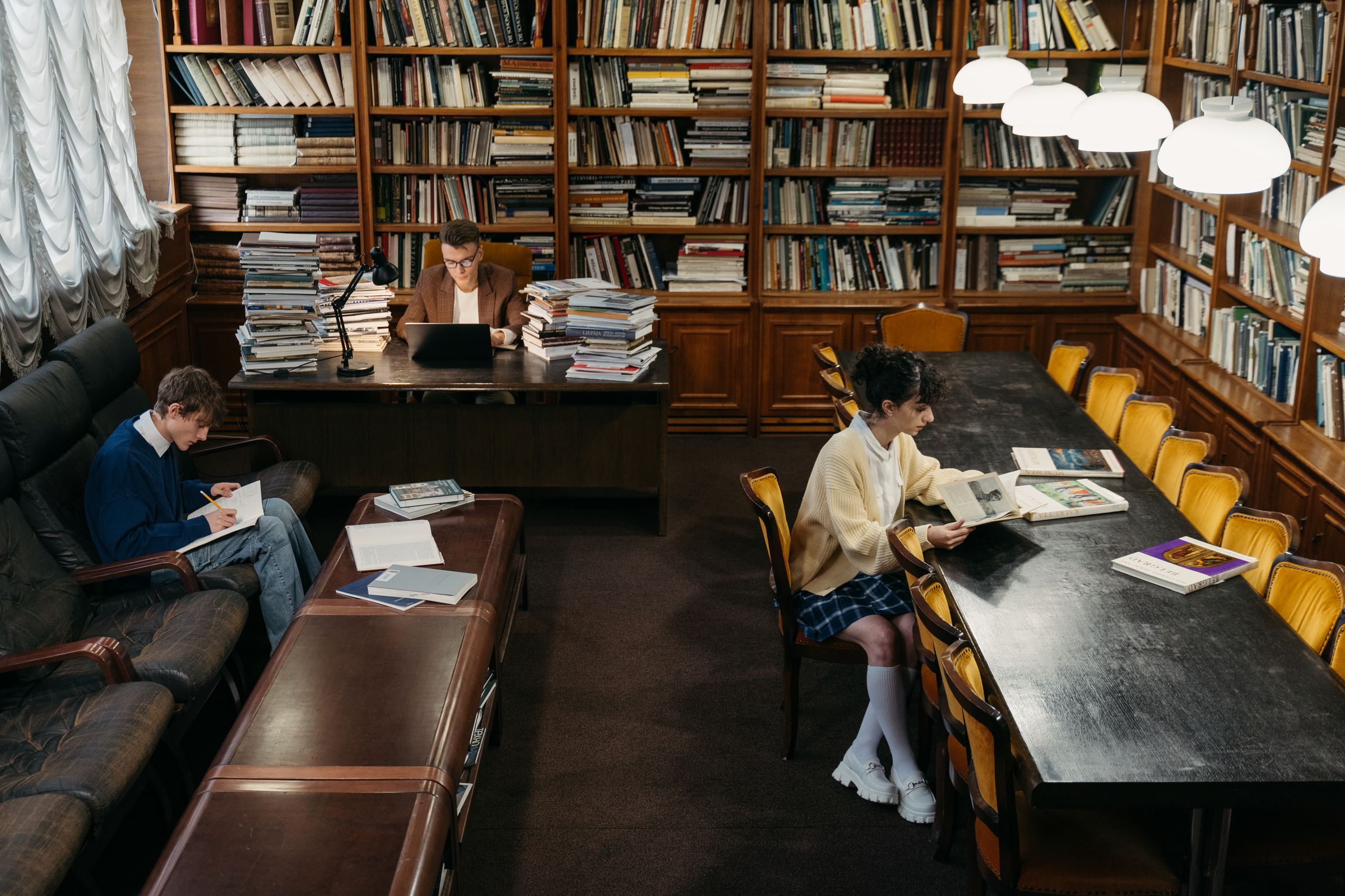 Illustrative photo: Students reading at study tables in a library