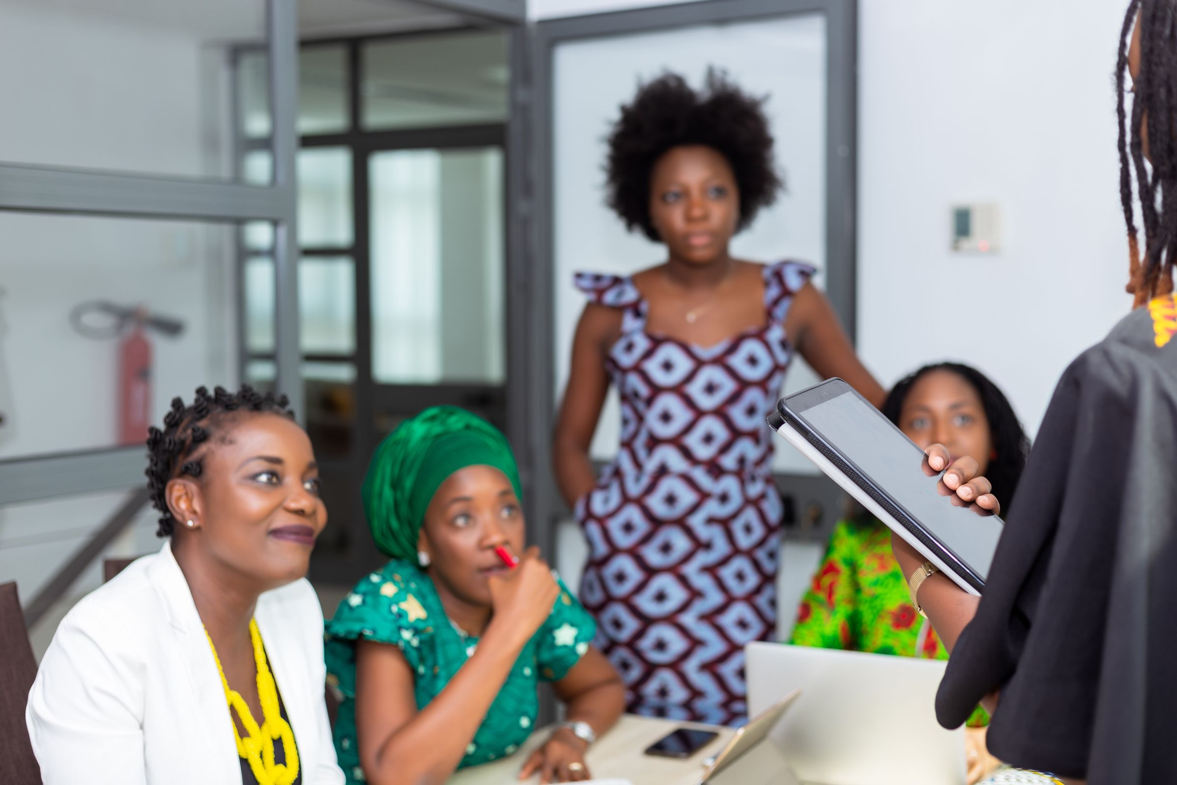 Illustrative photo: Women collaborating around a table in an office
