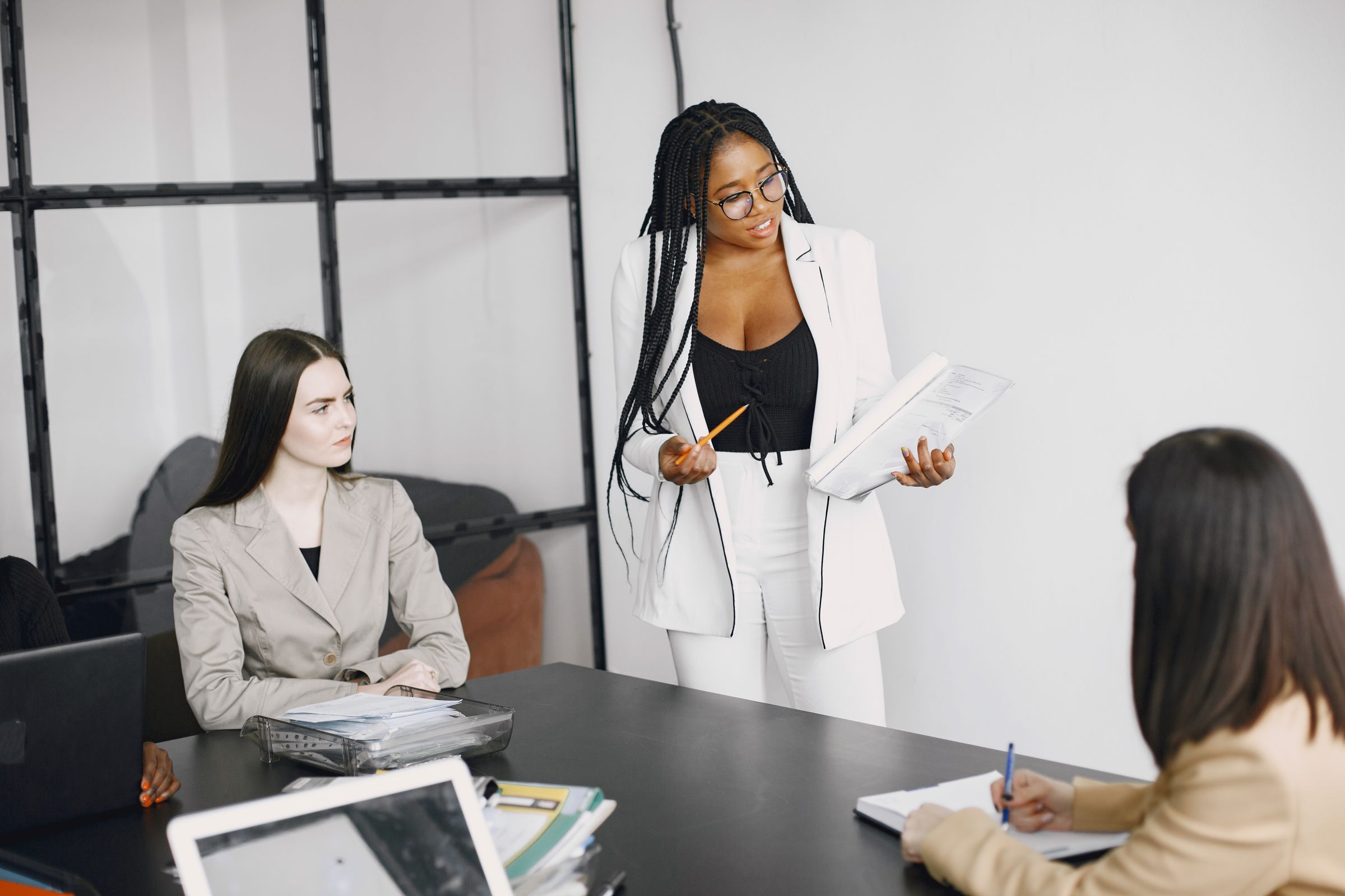 Illustrative photo: A woman leading a discussion with her team
