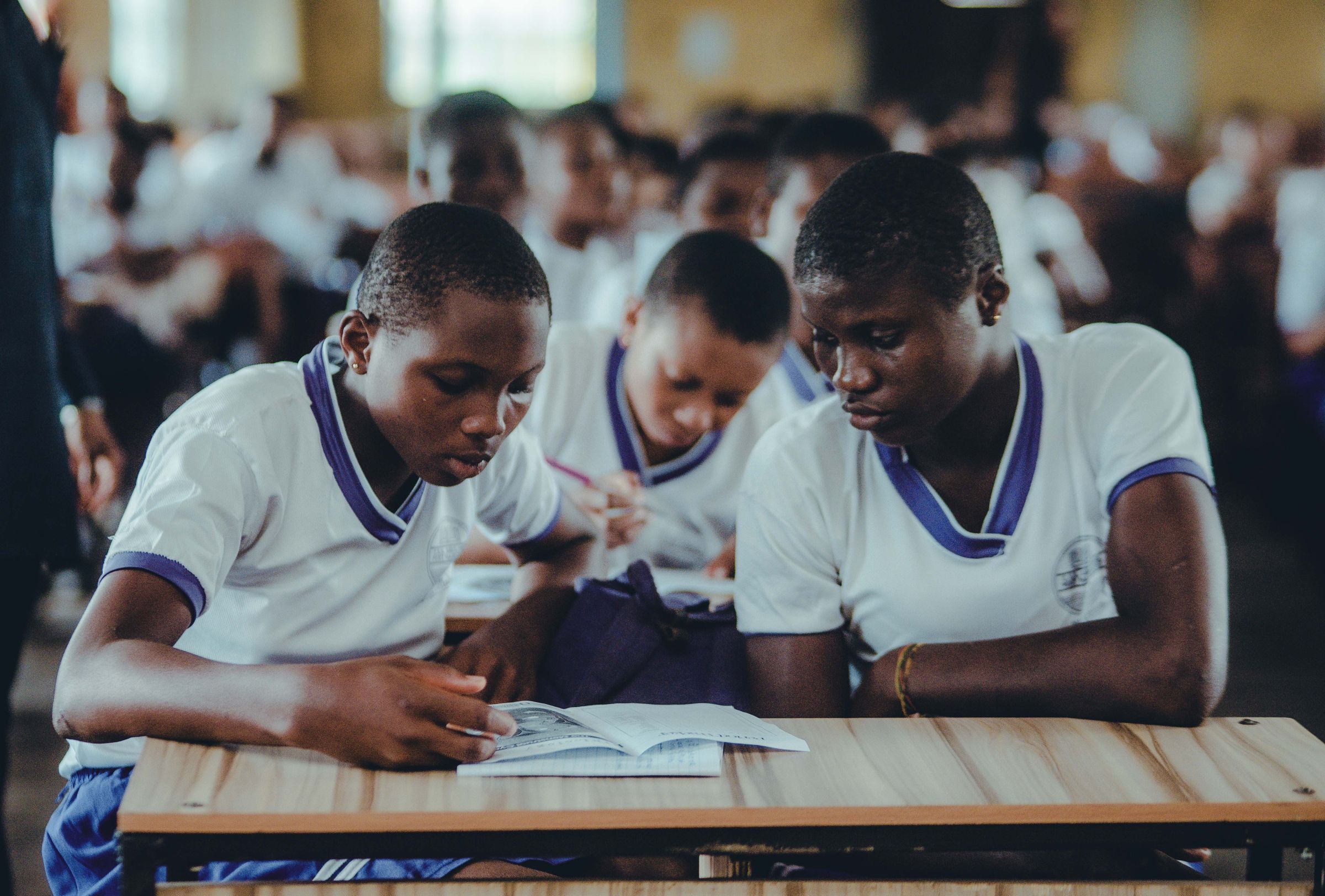 Illustrative photo: Students in school uniforms studying together in a classroom
