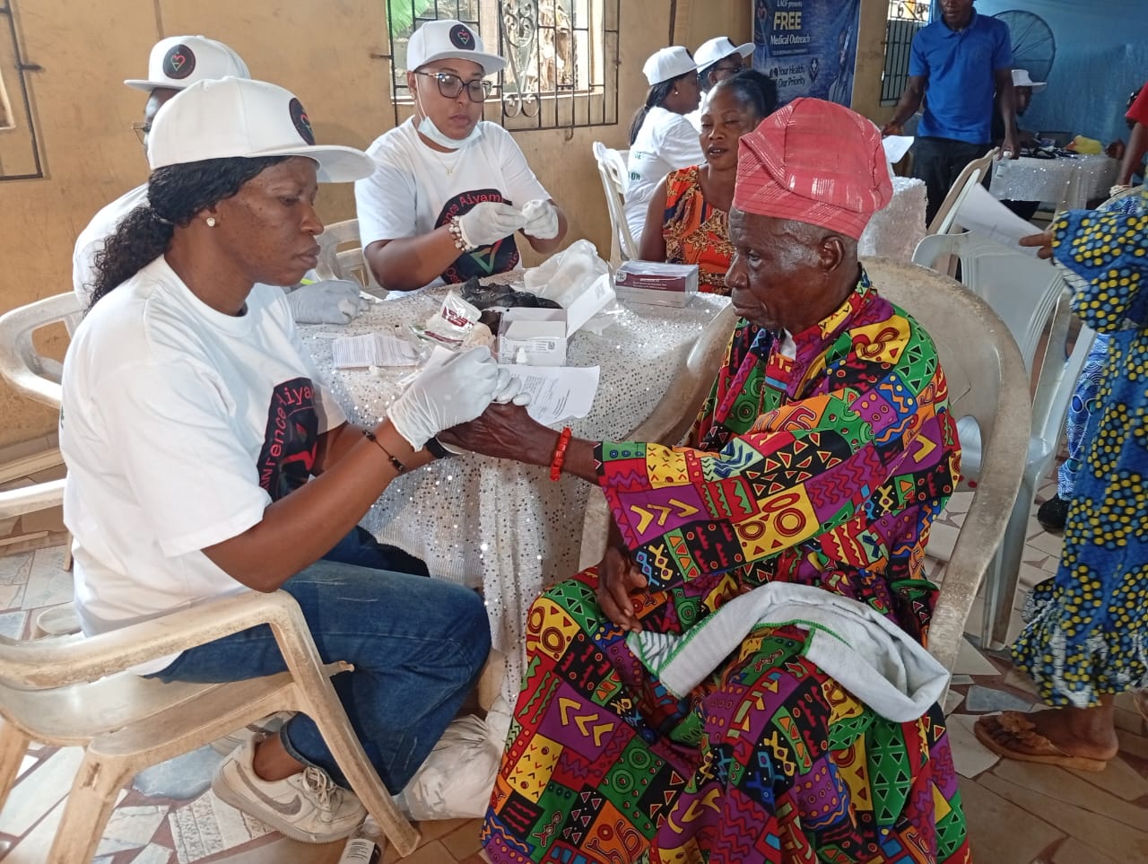 A LAOF volunteer checking a participant’s blood pressure