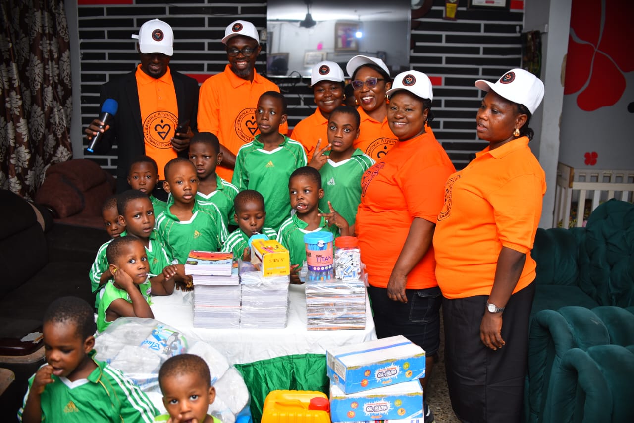 LAOF volunteers and children with boxes of donated supplies