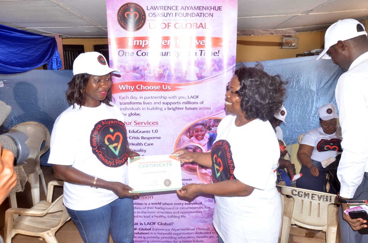 LAOF representatives presenting a document beside an outreach banner