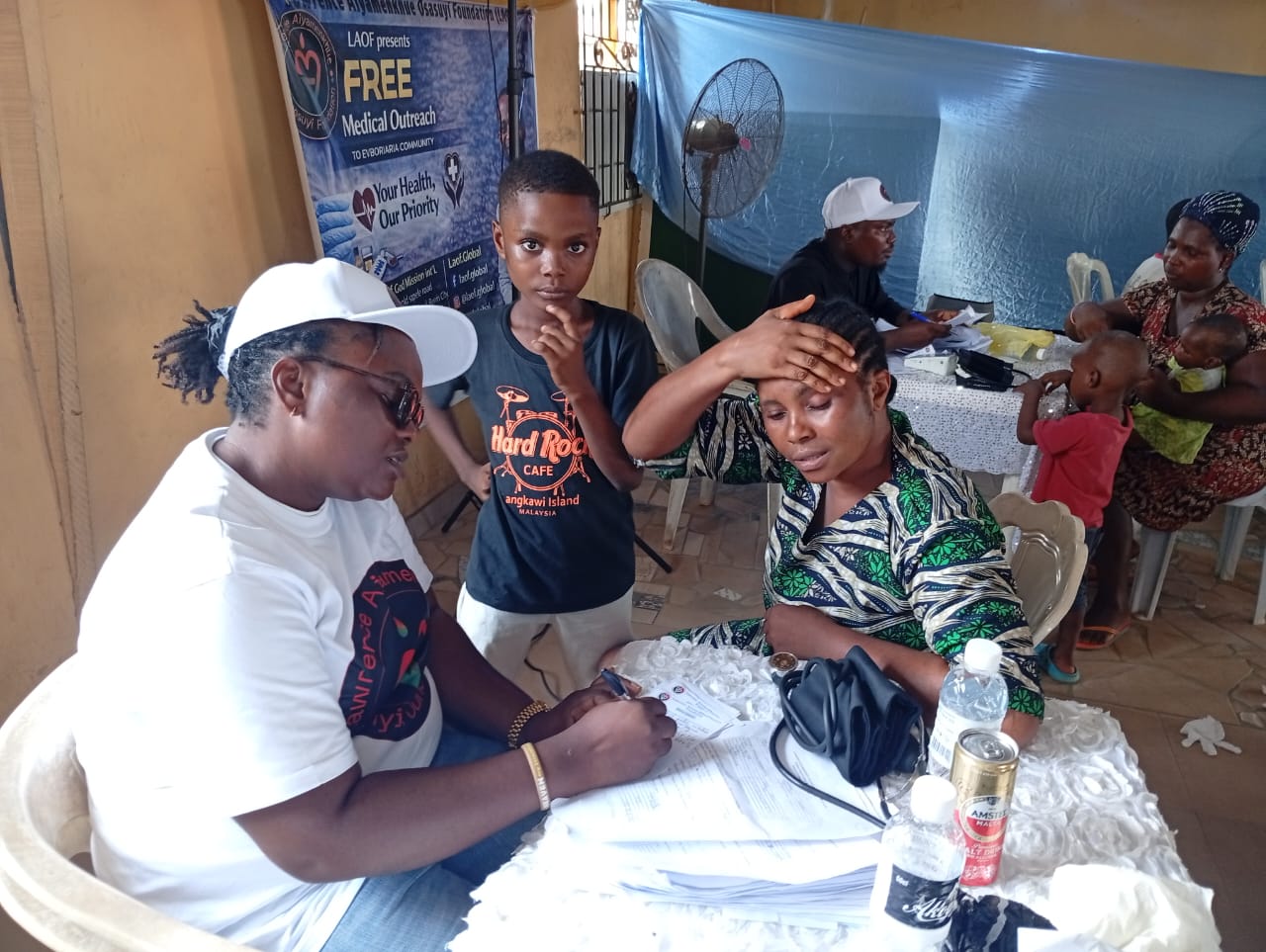 A LAOF volunteer recording information during a health consultation