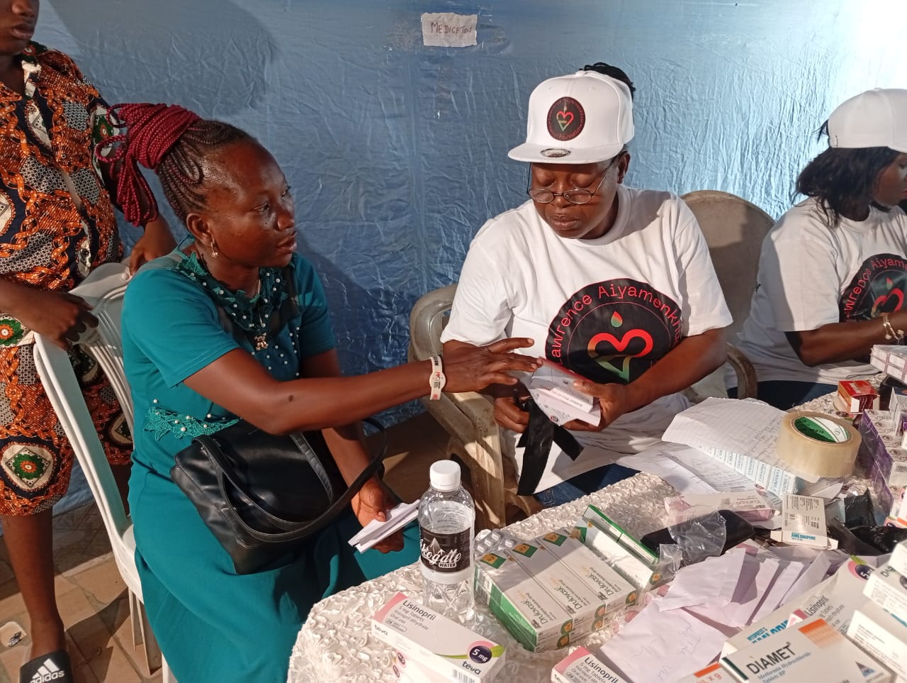 A LAOF volunteer checking a man’s blood pressure