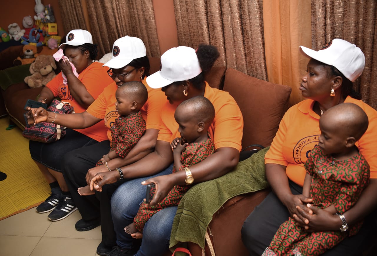 LAOF volunteers sitting alongside children and caregivers