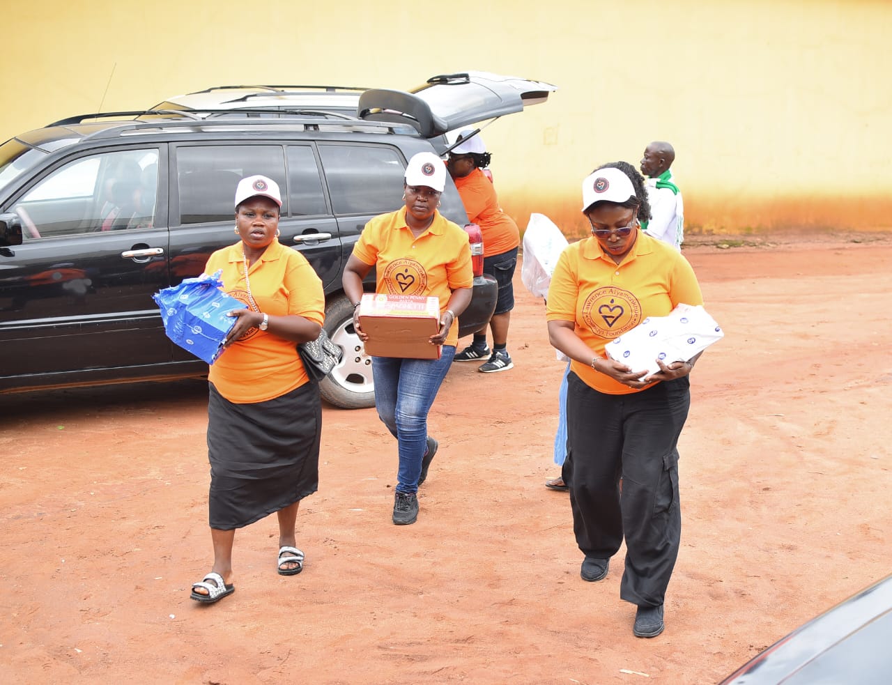 LAOF volunteers carrying boxes of supplies outdoors