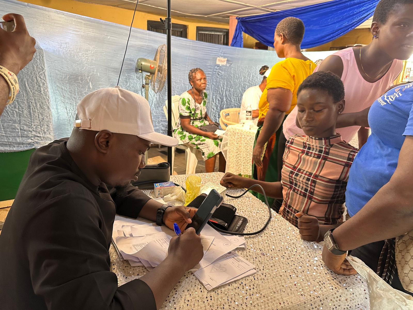A LAOF volunteer working at an outdoor outreach table