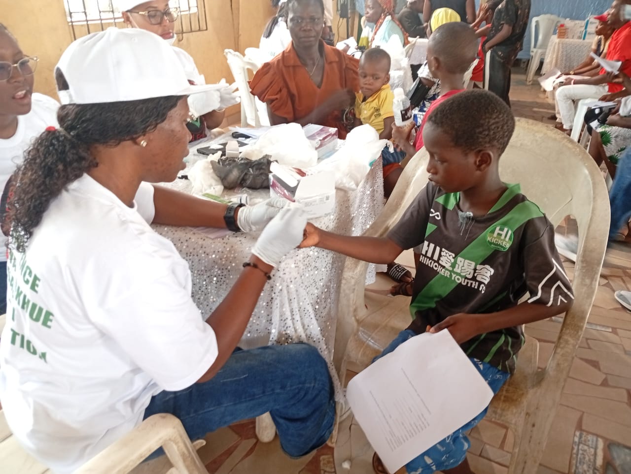 A LAOF volunteer providing care to a young participant