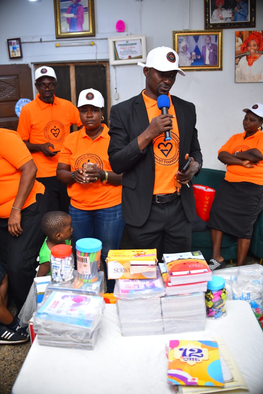 LAOF volunteers standing beside donated school and household supplies