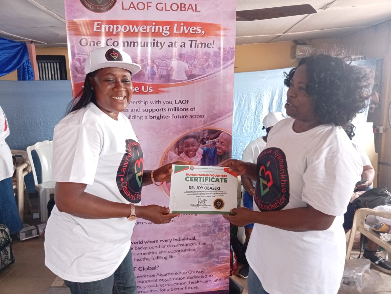 LAOF representatives presenting a certificate during an outreach event