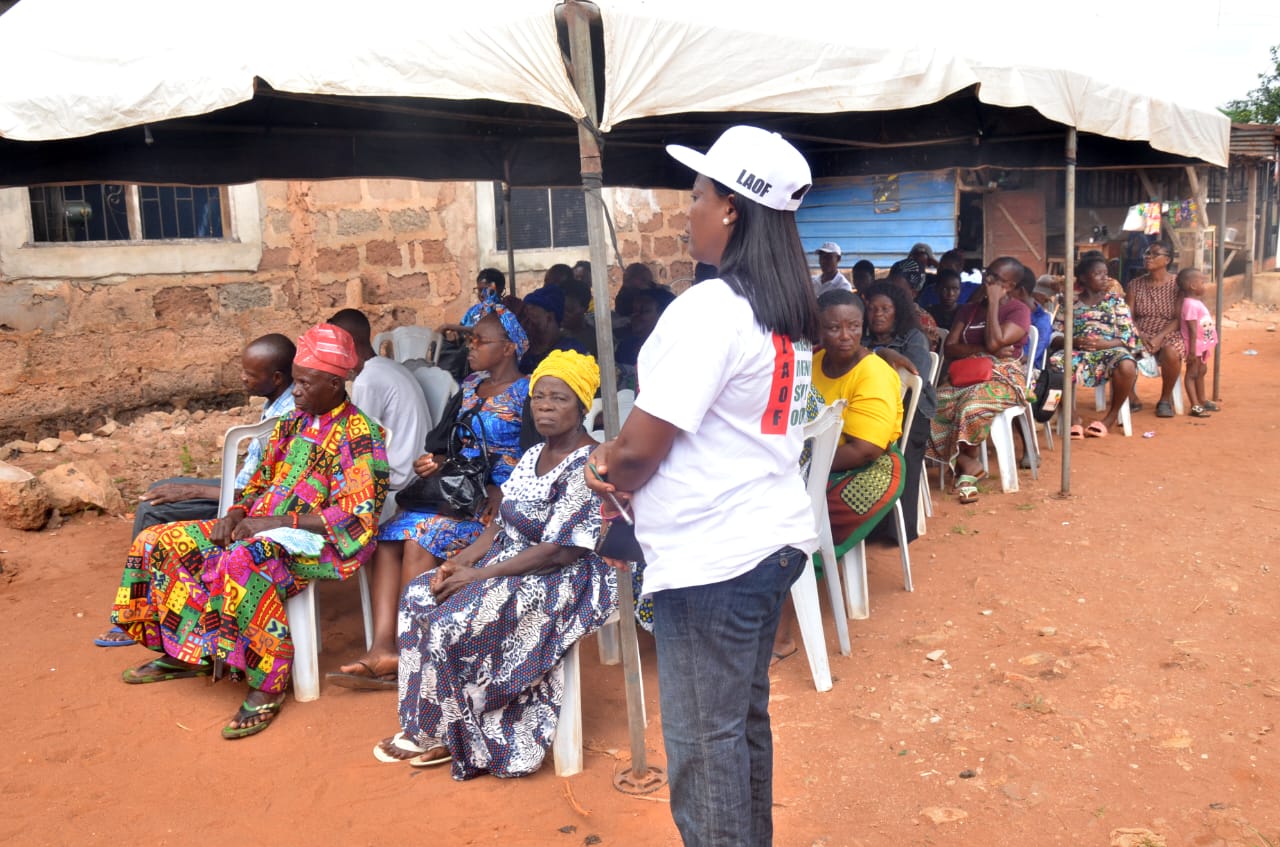 A LAOF volunteer addressing participants under a canopy
