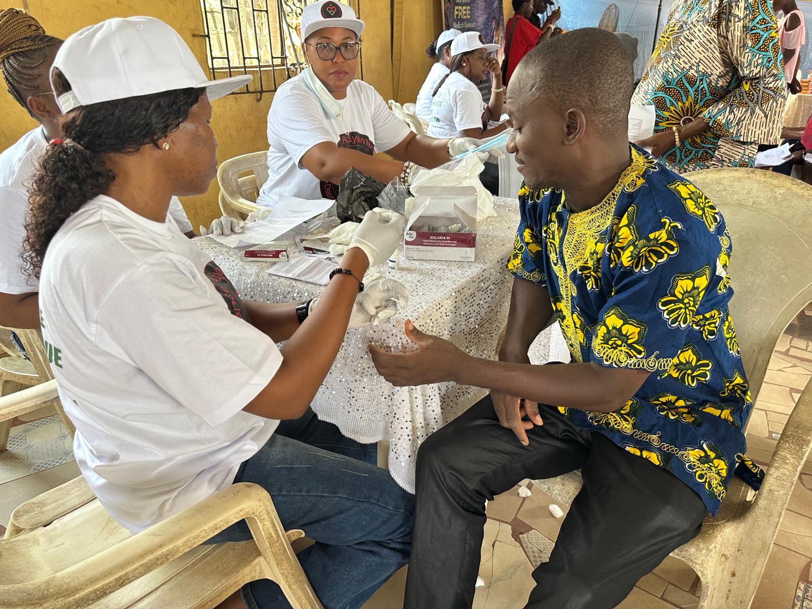 A LAOF volunteer providing a health check for a participant