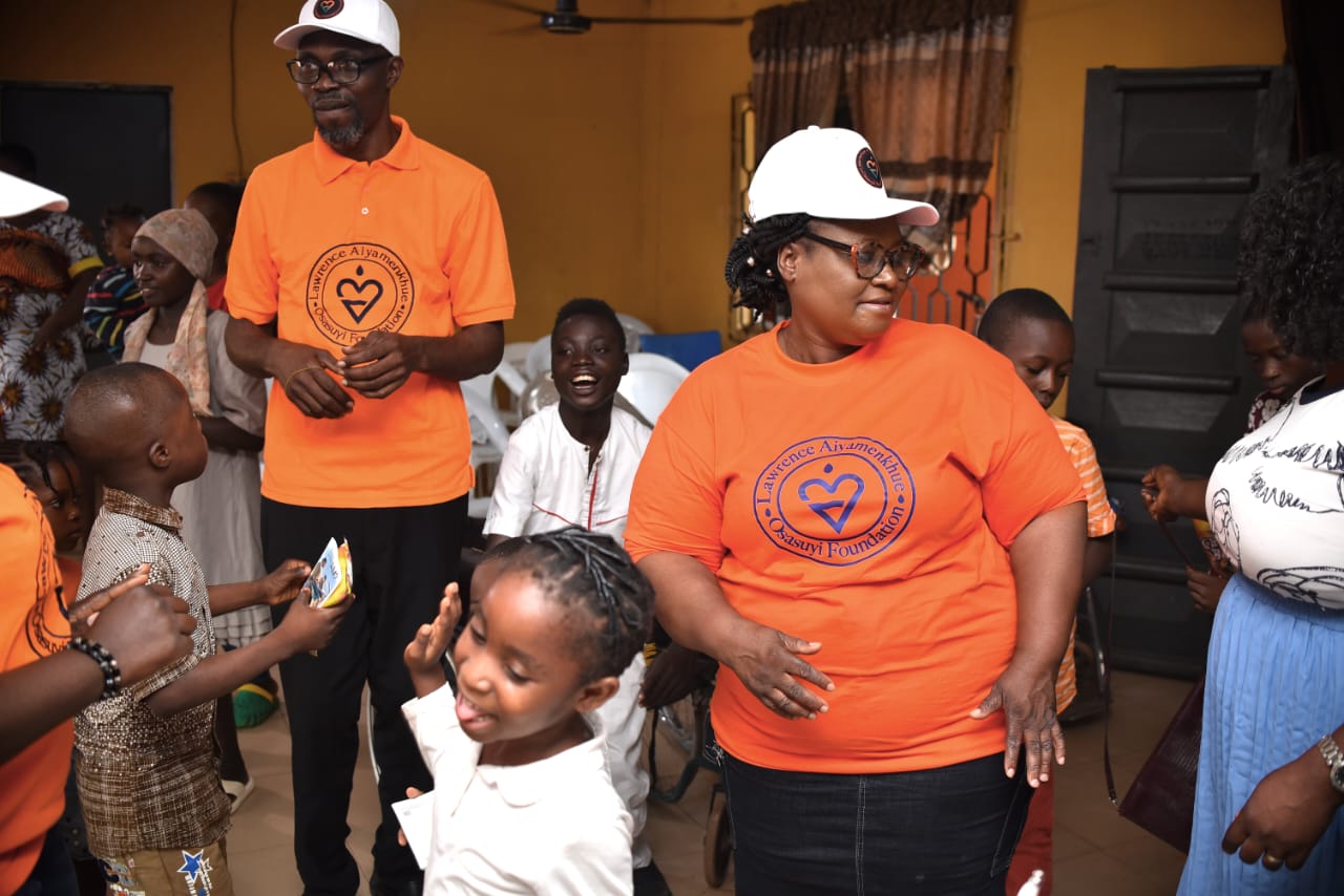 A LAOF volunteer standing with children during a community gathering