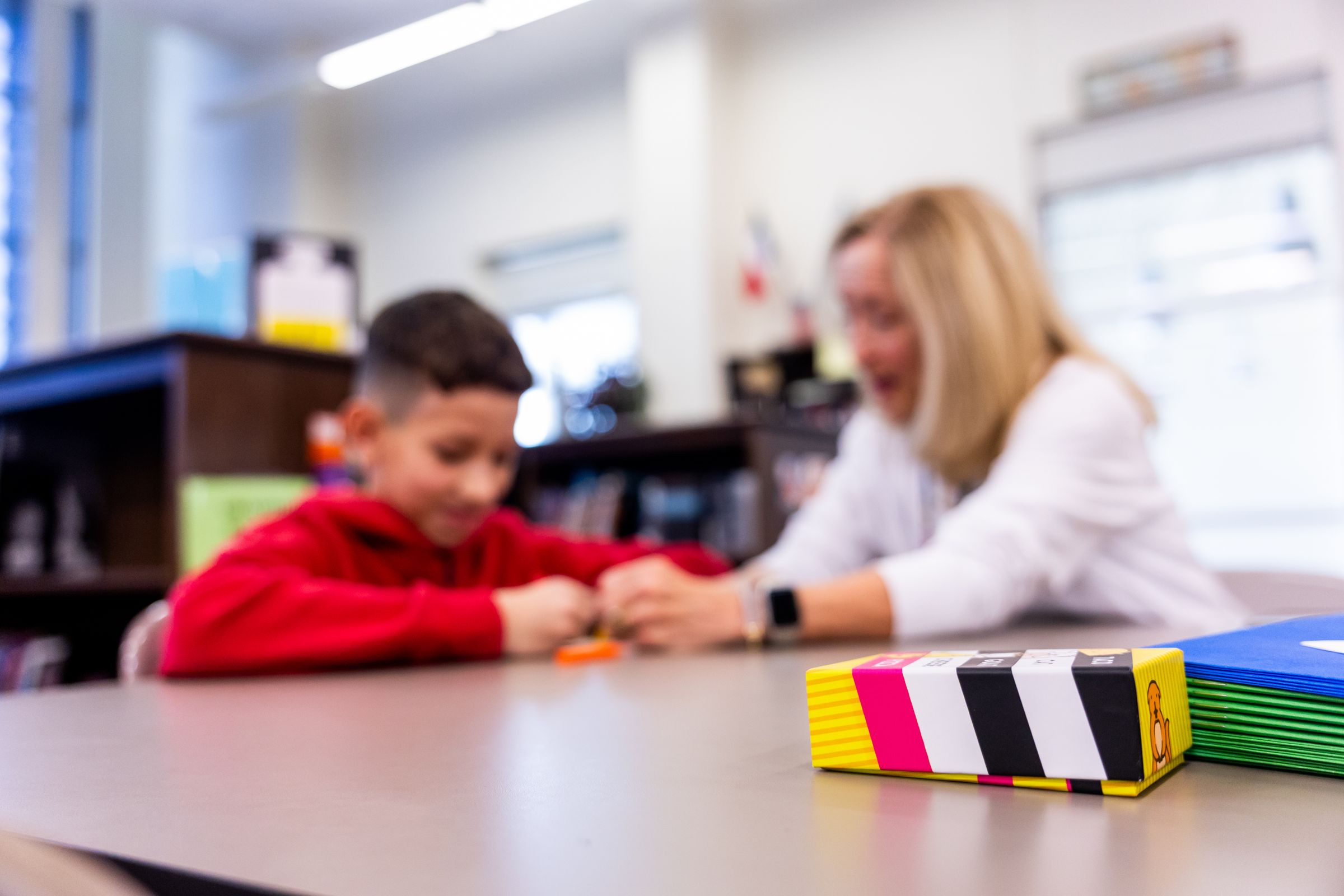 Illustrative photo: A teacher helping a student with classroom work
