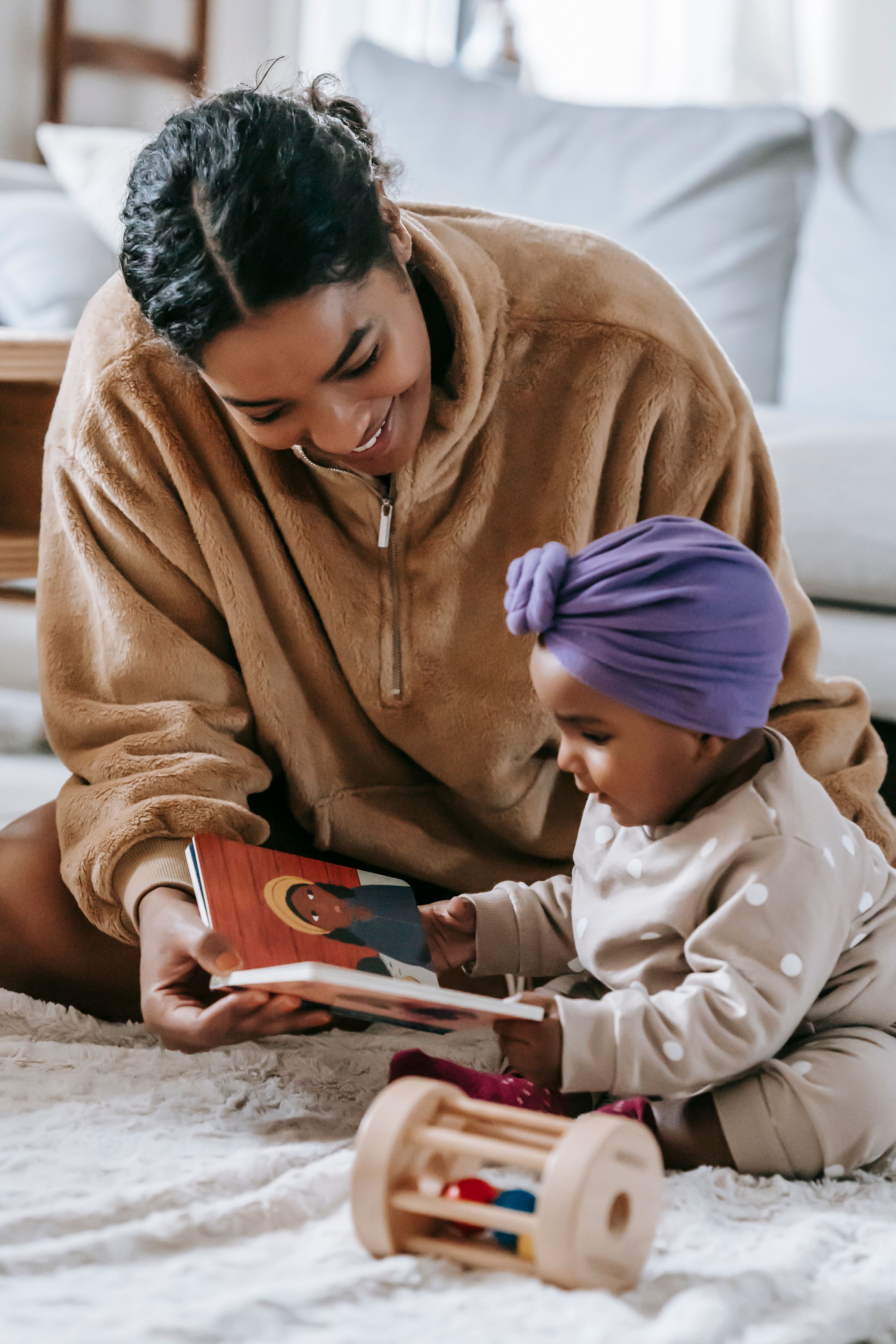 Illustrative photo: A mother helping her young child explore a book