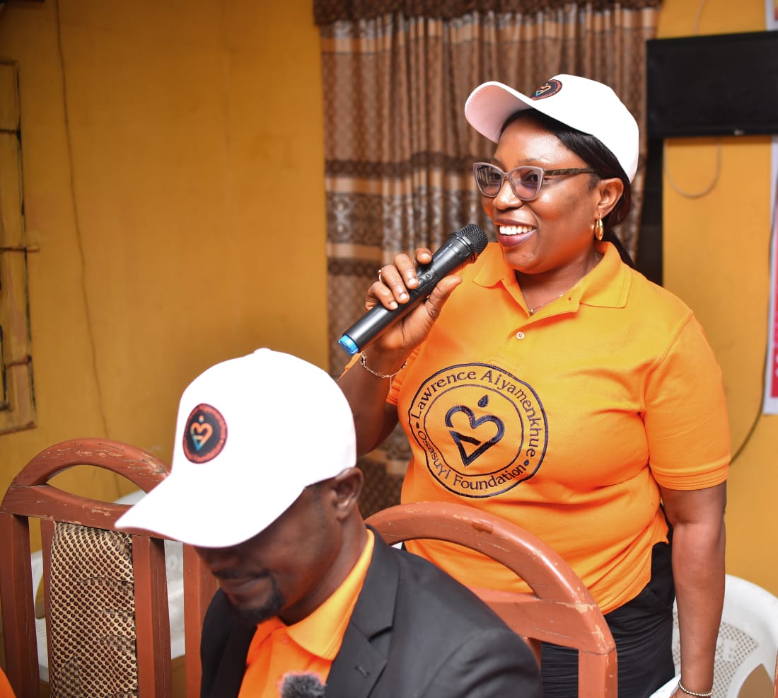 A LAOF volunteer with a microphone addressing participants
