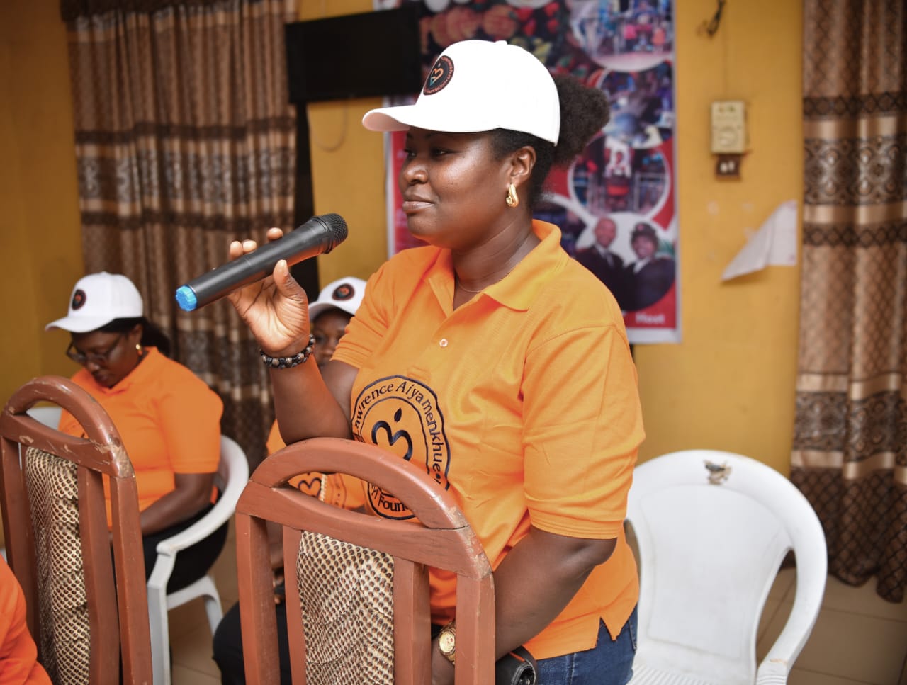 A LAOF volunteer speaking with seated community participants